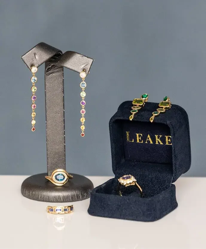 Jewelry display featuring colorful gemstone earrings and gold rings