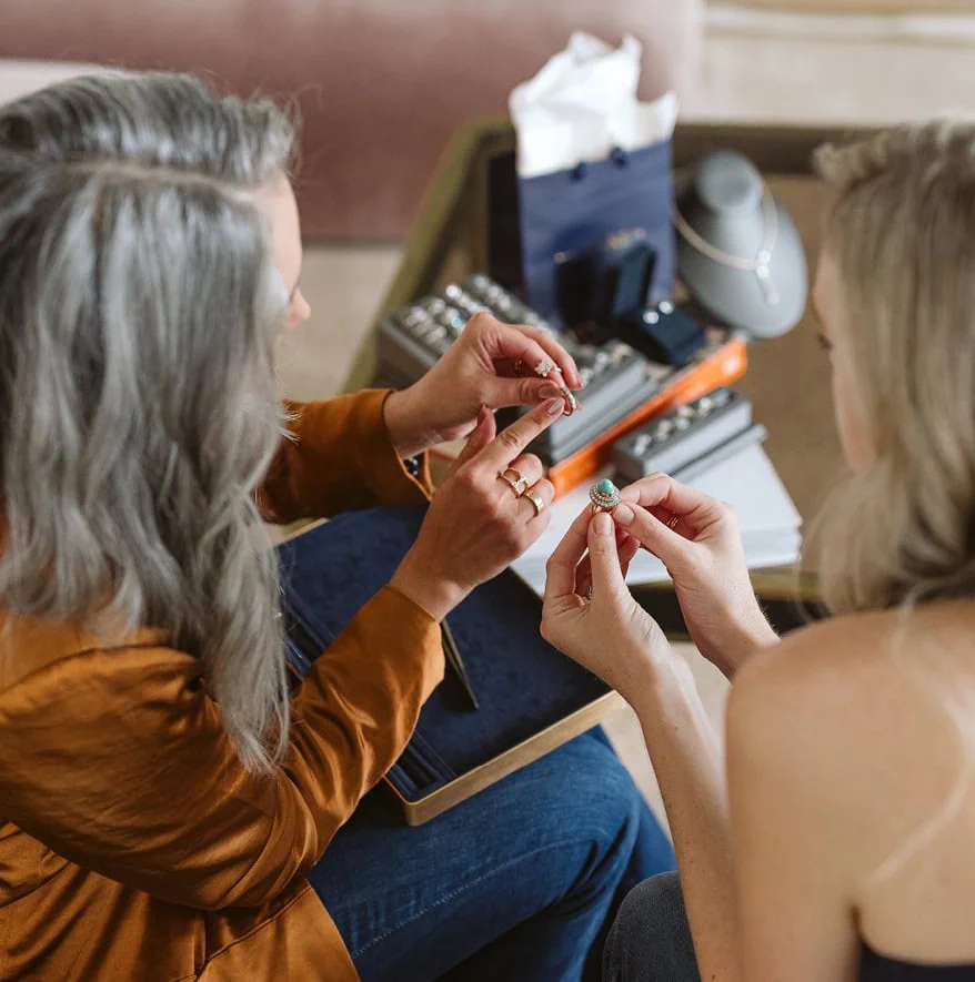 Jewelry designer showing ring options to a client during a consultation