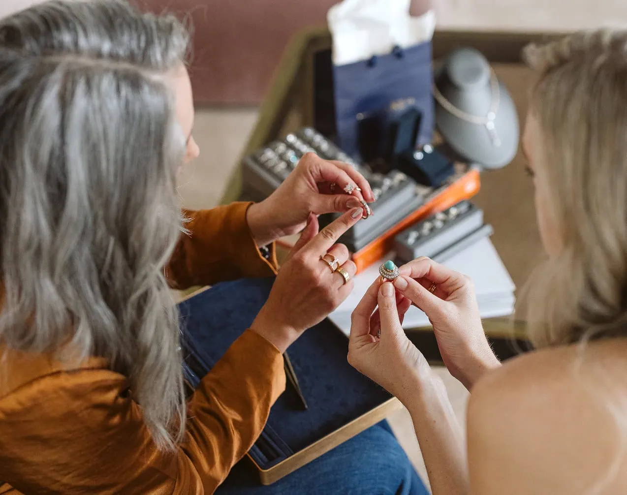 Jewelry designer, Sarah Rowe, discussing gemstone options with a client during a ring consultation