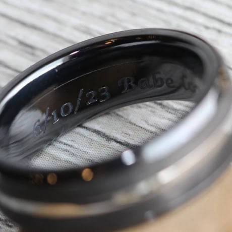 Close-up of an engraved message inside a wedding band