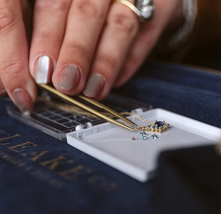 Jeweler placing a gemstone during gemstone replacement