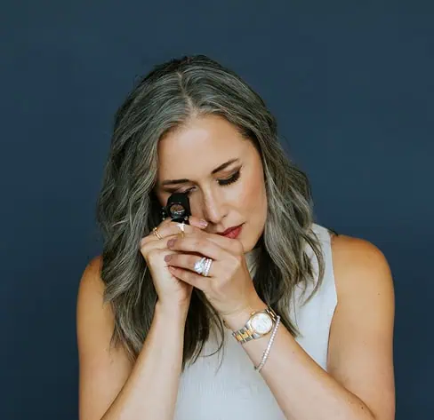 Jewelry designer inspecting a diamond with a jeweler’s loupe during the custom jewelry design process