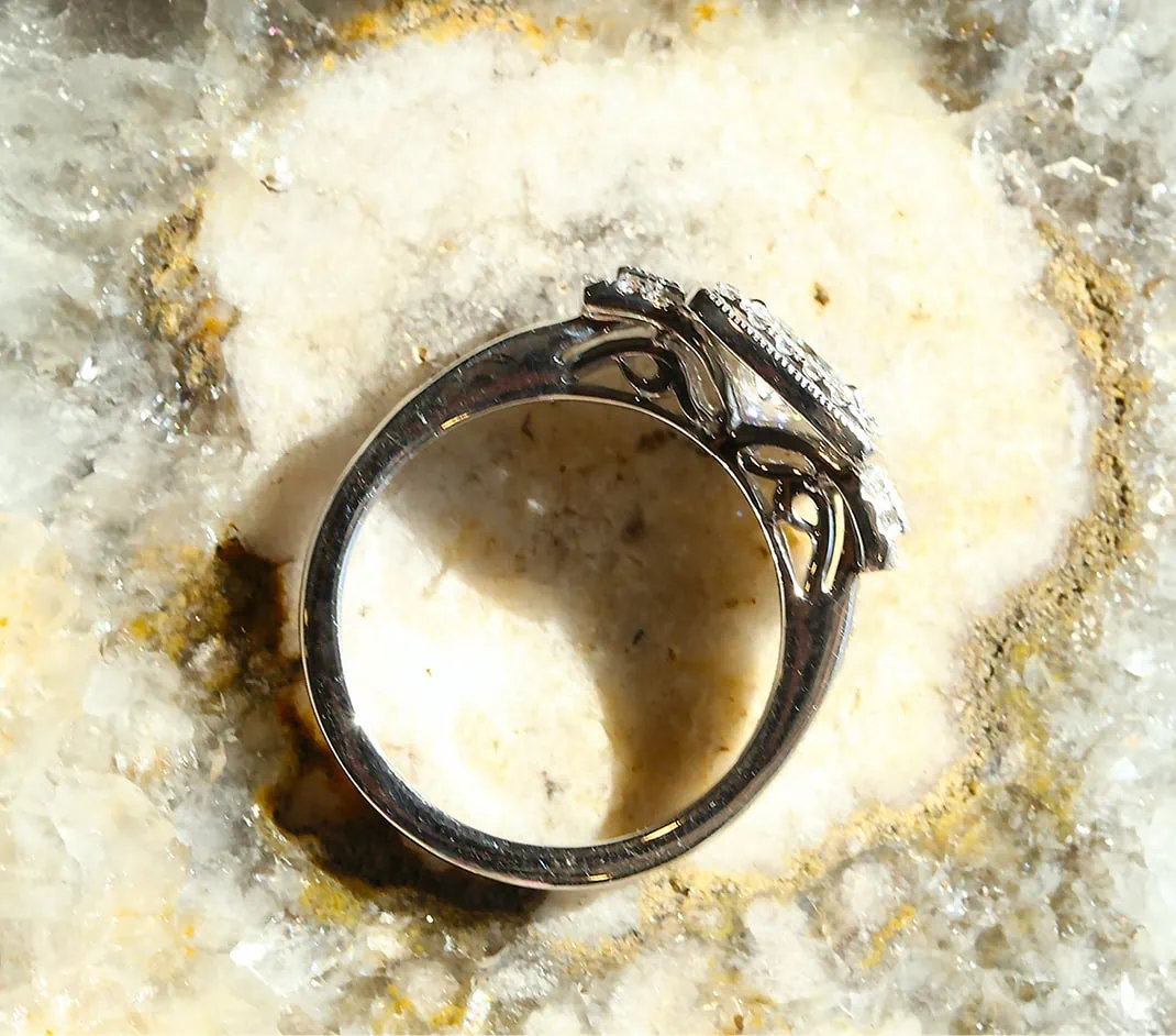 White gold diamond ring shown from the side during a jewelry repair evaluation