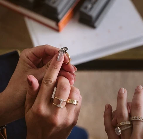 Jeweler examining a diamond ring during a jewelry repair consultation