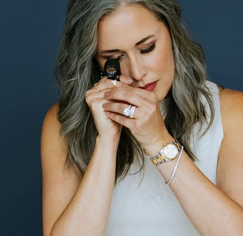 Jewelry expert inspecting a ring with a jeweler’s loupe during jewelry repair evaluation